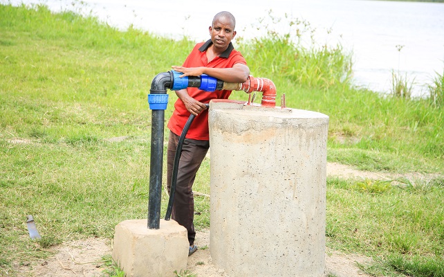 Man behind pipe for irrigation system