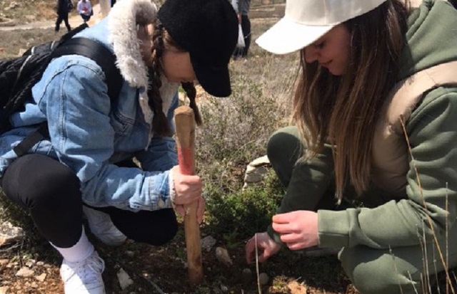Two girls planting seed bombs