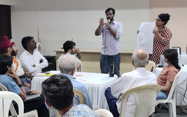 Men presenting results at workshop in Mumbai