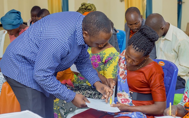 Community members filling-in the pre test Evaluation forms before the commencement of the 1st Sensitization session about climate change concepts, vulnerability and adaptation initiatiatives
