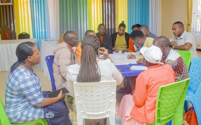 Project beneficiaries and community members in 1 of the group works to map out climate change risks during the 1st sensitization session