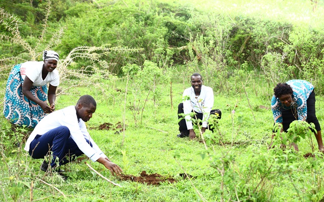Project participating  farmers planting fodder tree seedling after the demonstration and training at the communal grazing area
