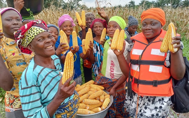Women's group photo after corn crop
